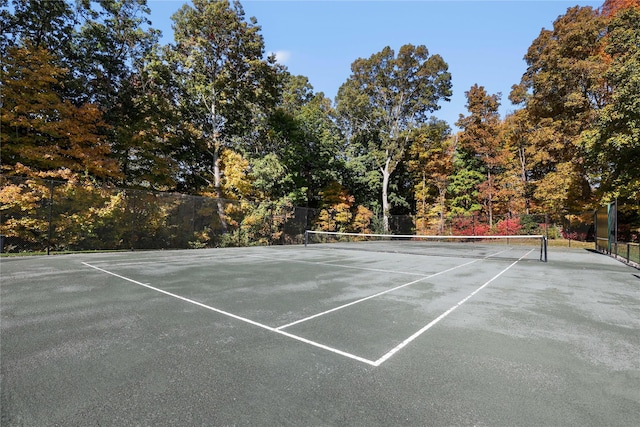 view of sport court featuring fence