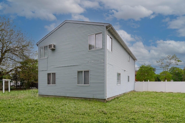 rear view of property with an AC wall unit