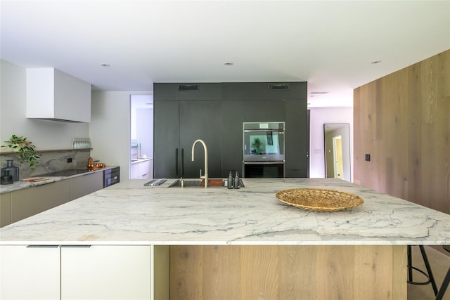 474 Rte 199, Red Hook, NY 12571 - kitchen with modern cabinets, a sink, stainless steel double oven, a spacious island, and light stone counters