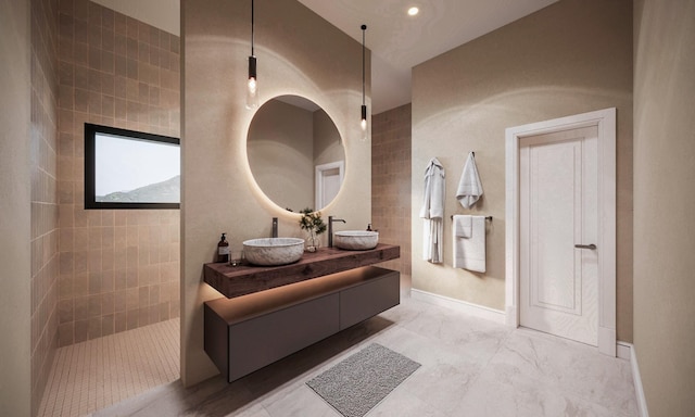 bathroom with double vanity and a walk in shower