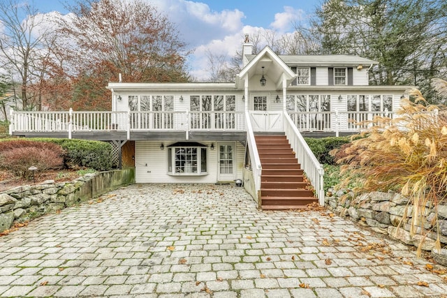 121 Thiells Rd, Stony Point, NY 10980 - rear view of property with decorative driveway, a chimney, stairs, and a wooden deck