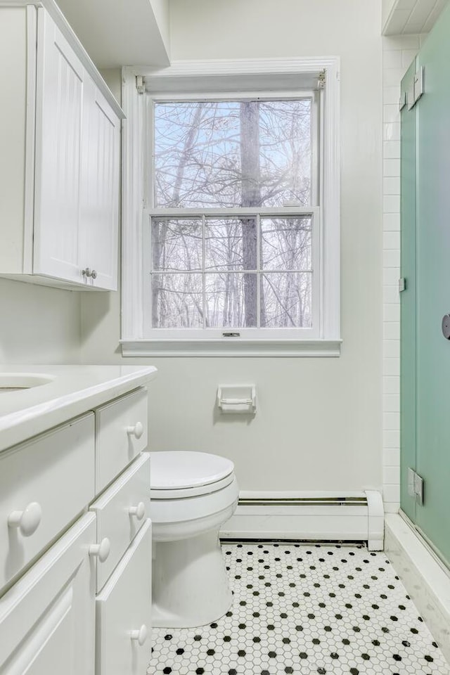 121 Thiells Rd, Stony Point, NY 10980 - full bathroom featuring vanity, toilet, tile patterned floors, a baseboard radiator, and a stall shower