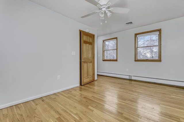 121 Thiells Rd, Stony Point, NY 10980 - empty room featuring visible vents, baseboards, baseboard heating, a ceiling fan, and light wood-style flooring