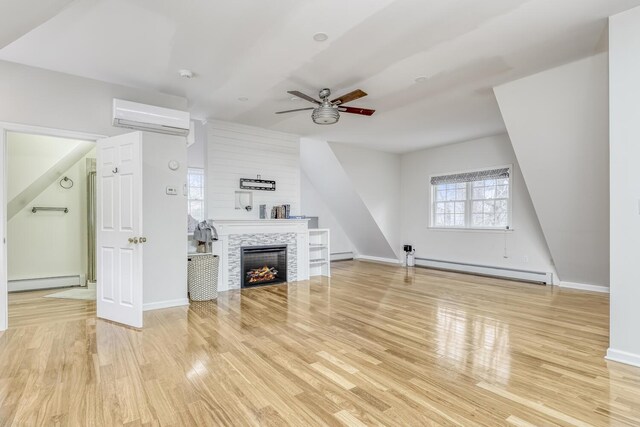 121 Thiells Rd, Stony Point, NY 10980 - unfurnished living room featuring a ceiling fan, a baseboard heating unit, wood finished floors, and an AC wall unit