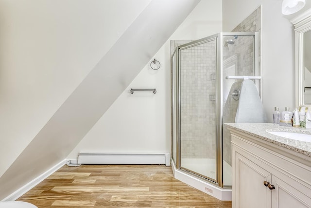 121 Thiells Rd, Stony Point, NY 10980 - bathroom with vanity, a stall shower, wood finished floors, and a baseboard radiator