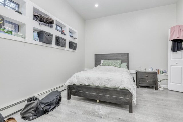 121 Thiells Rd, Stony Point, NY 10980 - bedroom with a baseboard heating unit, recessed lighting, and wood finished floors