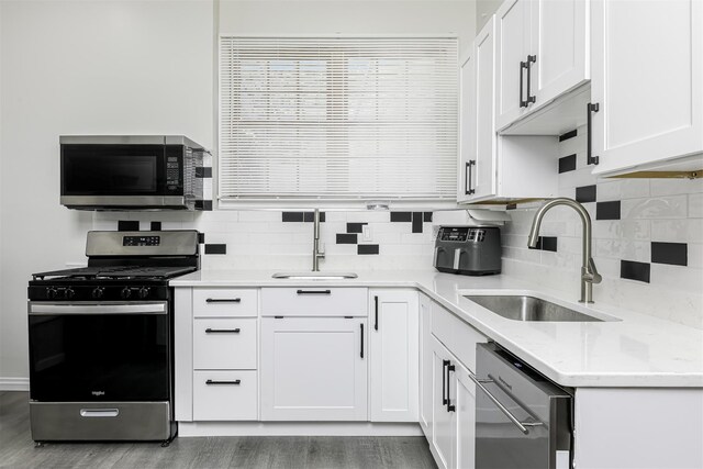 121 Thiells Rd, Stony Point, NY 10980 - kitchen with a sink, appliances with stainless steel finishes, white cabinets, and tasteful backsplash