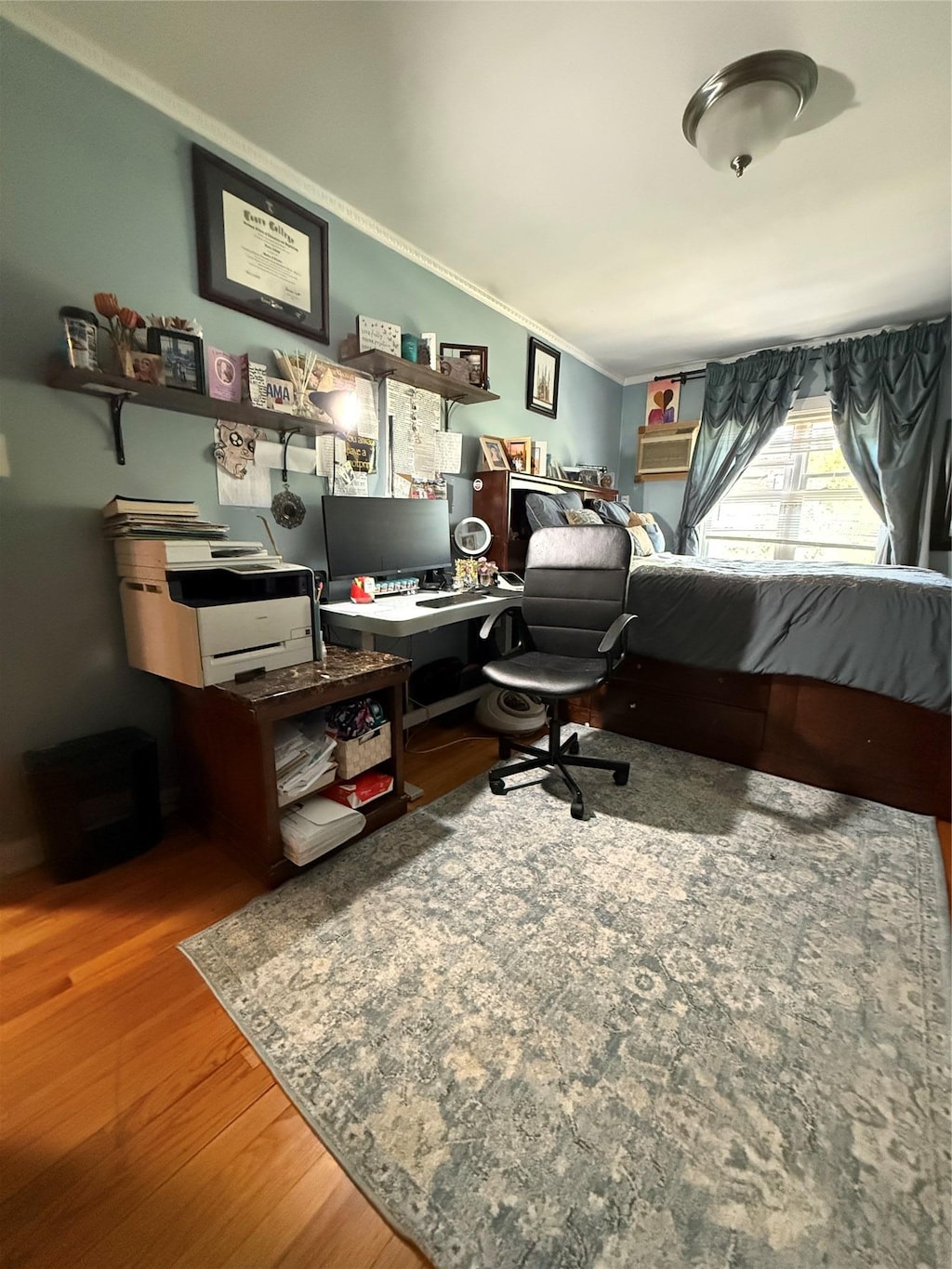 office space with ornamental molding and wood finished floors