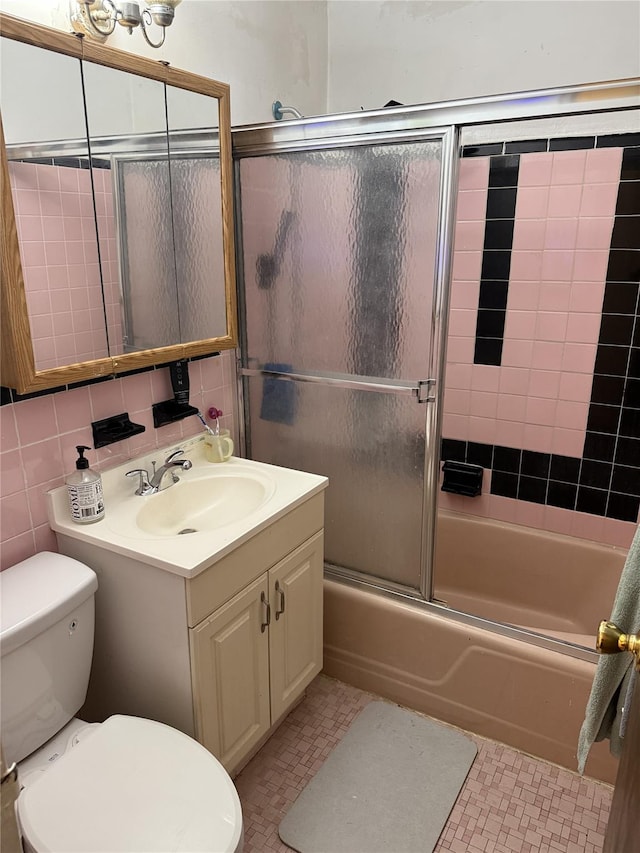 62-23 69th Pl, Middle Village, NY 11379 - bathroom with vanity, toilet, and bath / shower combo with glass door