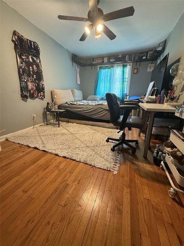 62-23 69th Pl, Middle Village, NY 11379 - bedroom with wood finished floors, a ceiling fan, and an office area