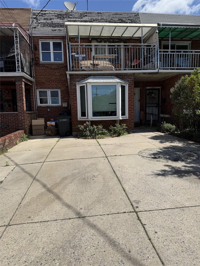 62-23 69th Pl, Middle Village, NY 11379 - rear view of property with brick siding