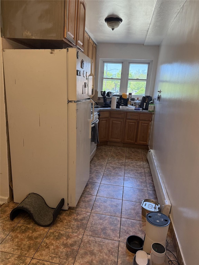 62-23 69th Pl, Middle Village, NY 11379 - kitchen featuring freestanding refrigerator, a textured ceiling, and stove