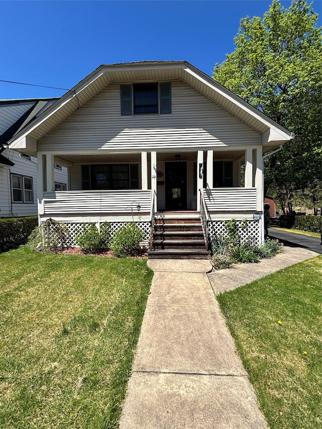 bungalow-style house featuring a porch and a front lawn