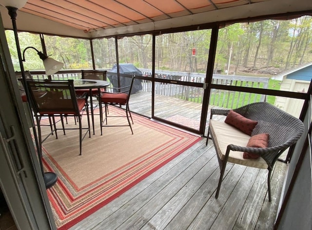 sunroom featuring outdoor dining space