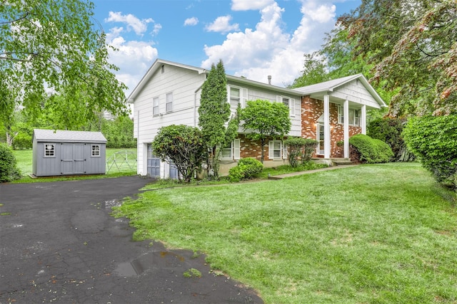12 Jay Ct, Monsey, NY 10952 - view of front of house with an attached garage, a front lawn, an outbuilding, driveway, and a storage unit