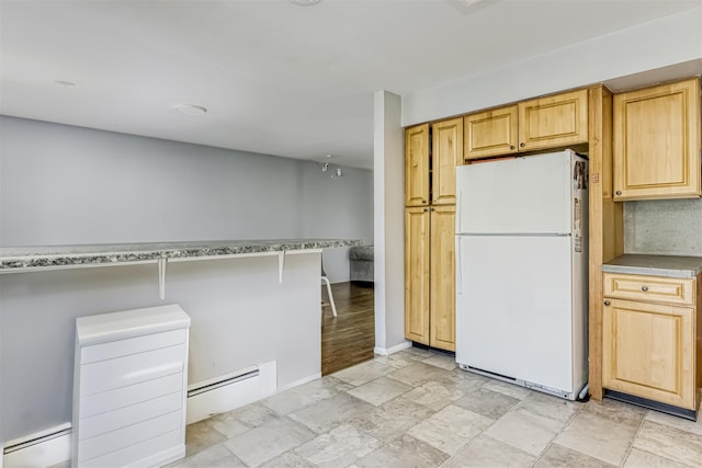 12 Jay Ct, Monsey, NY 10952 - kitchen with freestanding refrigerator, baseboard heating, a baseboard radiator, baseboards, and light stone finish floors