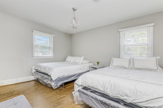 12 Jay Ct, Monsey, NY 10952 - bedroom with wood finished floors, baseboards, and a chandelier