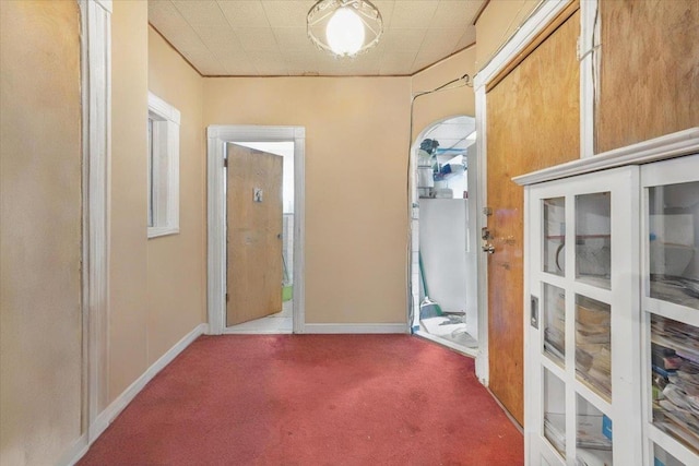 corridor featuring carpet floors and baseboards
