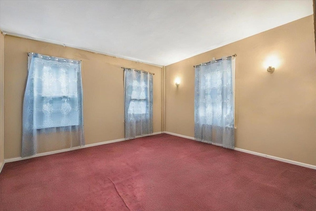empty room with baseboards and carpet