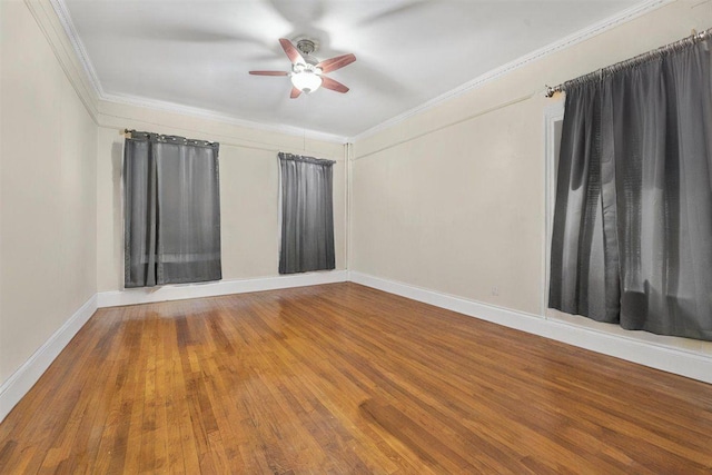 unfurnished room with baseboards, a ceiling fan, wood finished floors, and ornamental molding