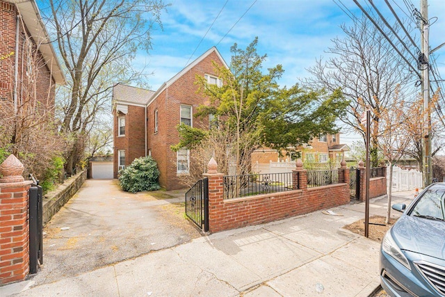 view of front of house with brick siding, a gate, and a fenced front yard