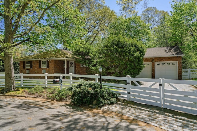 65 Preston St, Huntington, NY 11743 - view of front of property featuring brick siding, a fenced front yard, and a garage