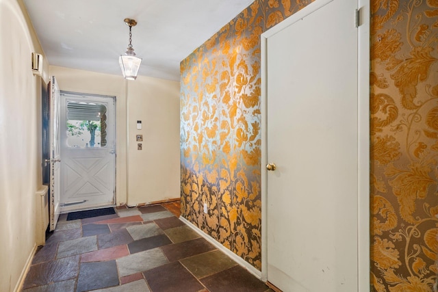 65 Preston St, Huntington, NY 11743 - entryway with wallpapered walls, baseboards, and stone finish flooring