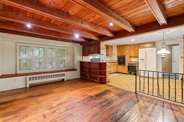 65 Preston St, Huntington, NY 11743 - kitchen featuring radiator, white fridge with ice dispenser, black oven, light wood-style flooring, and wooden ceiling with exposed beams