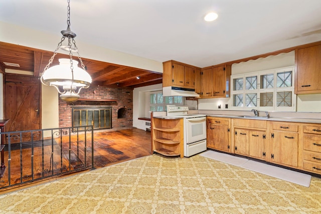 65 Preston St, Huntington, NY 11743 - kitchen with white range with electric stovetop, under cabinet range hood, a sink, a fireplace, and open shelves