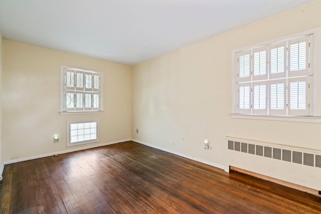 65 Preston St, Huntington, NY 11743 - spare room with radiator, baseboards, and hardwood / wood-style floors