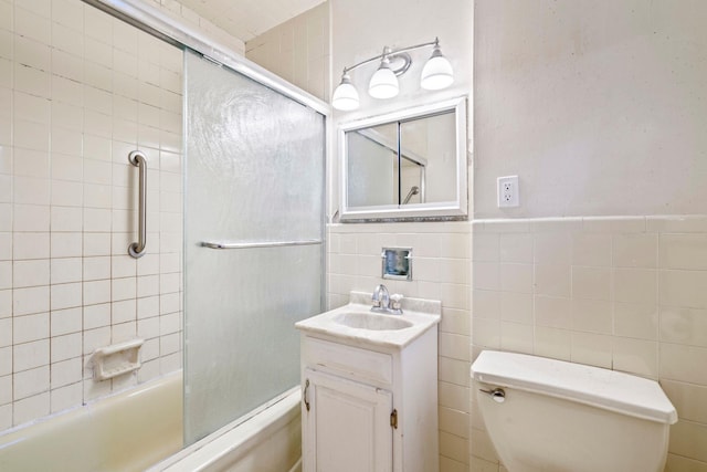 65 Preston St, Huntington, NY 11743 - full bath featuring toilet, vanity, shower / bath combination with glass door, and tile walls