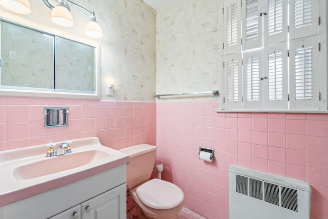 65 Preston St, Huntington, NY 11743 - bathroom featuring radiator, tile walls, vanity, toilet, and wallpapered walls