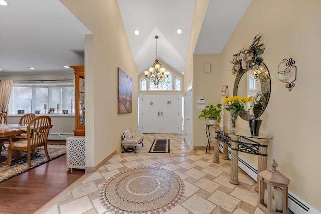foyer with a healthy amount of sunlight, baseboards, and baseboard heating