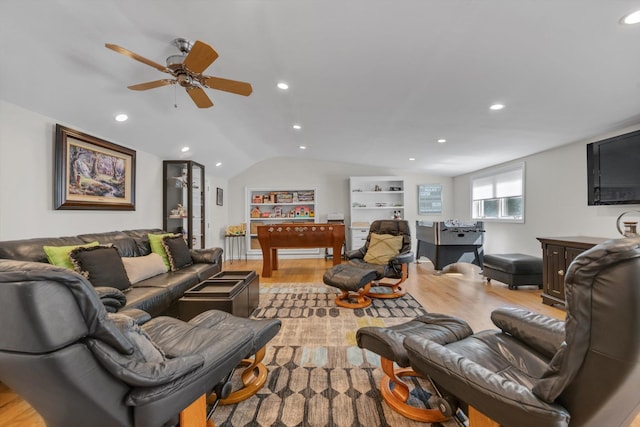 living room with light wood-style floors, recessed lighting, and vaulted ceiling
