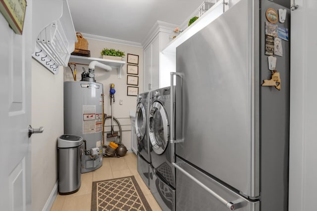 laundry area with crown molding, washer and dryer, cabinet space, water heater, and light tile patterned floors
