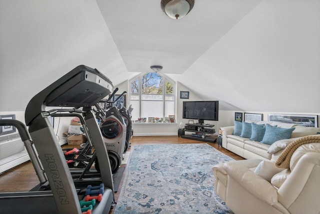 workout room with wood finished floors and vaulted ceiling