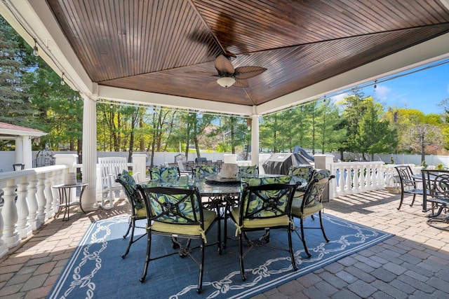 view of patio / terrace with a fenced backyard, a ceiling fan, and outdoor dining space