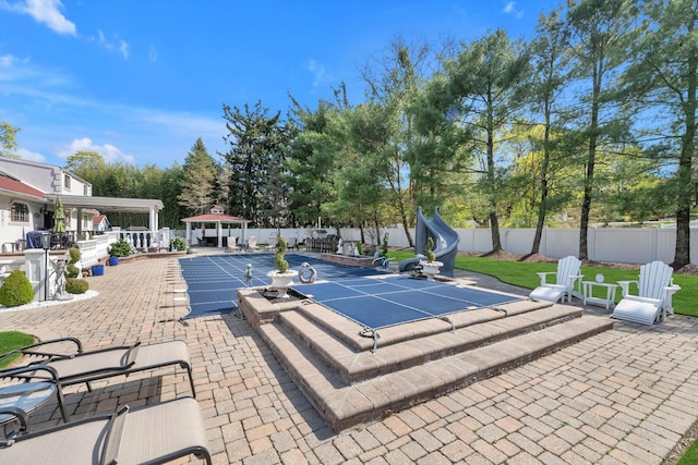view of swimming pool with a fenced backyard, a patio, and a gazebo