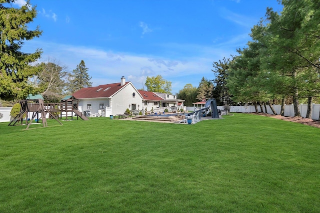 view of yard featuring fence and a playground