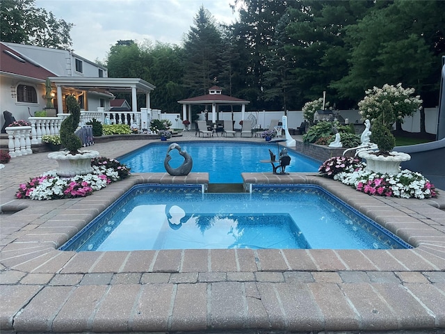view of swimming pool featuring a fenced backyard, a fenced in pool, a patio area, a gazebo, and an in ground hot tub