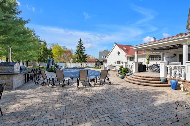view of patio / terrace with fence, a ceiling fan, and outdoor dining area