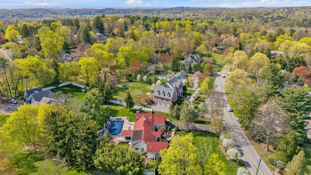 birds eye view of property with a wooded view