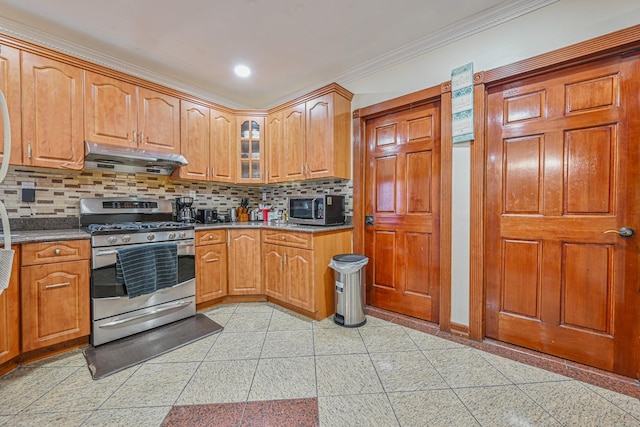 kitchen with crown molding, stainless steel appliances, decorative backsplash, under cabinet range hood, and glass insert cabinets