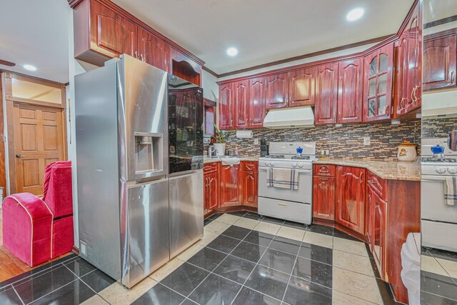 kitchen featuring stainless steel refrigerator with ice dispenser, extractor fan, white range with gas stovetop, and dark brown cabinets
