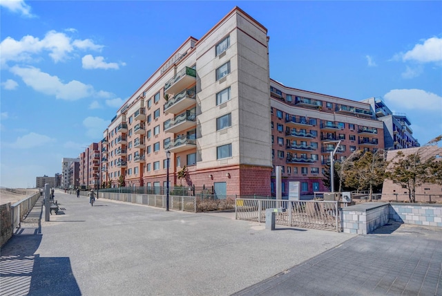 136 Bch 117th St Unit 410, Rockaway Park, NY 11694 - view of building exterior with fence