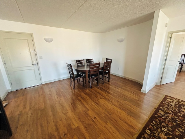 136 Bch 117th St Unit 410, Rockaway Park, NY 11694 - dining space featuring a textured ceiling, baseboards, and wood finished floors