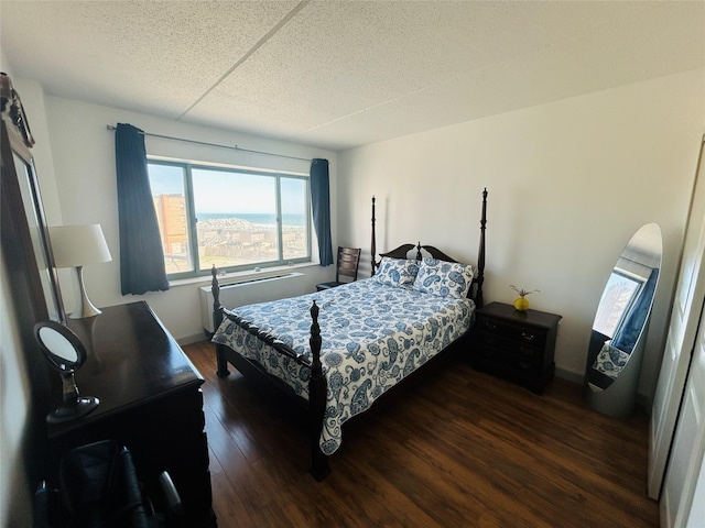 136 Bch 117th St Unit 410, Rockaway Park, NY 11694 - bedroom with baseboards, a textured ceiling, and wood finished floors