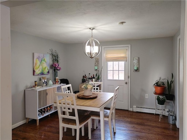dining area with an inviting chandelier, a baseboard heating unit, and dark wood finished floors