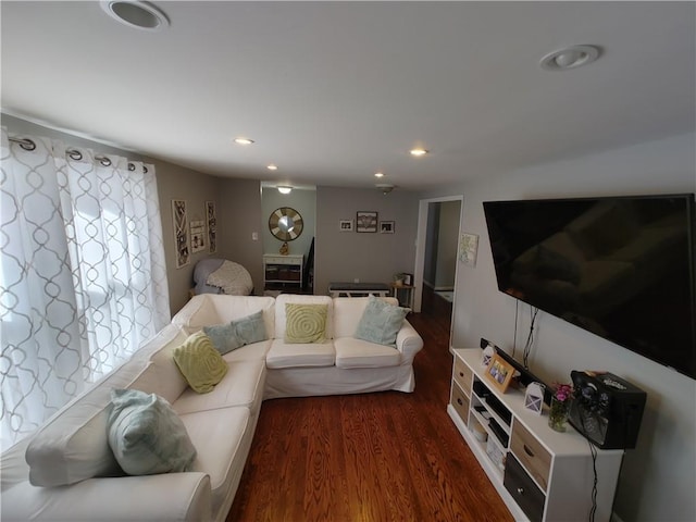 living room with recessed lighting and dark wood-style flooring