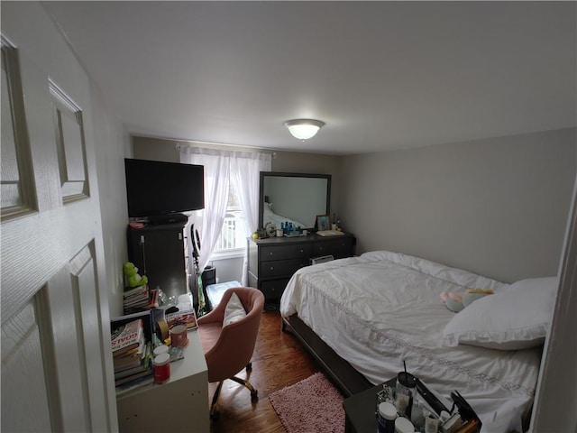 bedroom featuring dark wood-style floors
